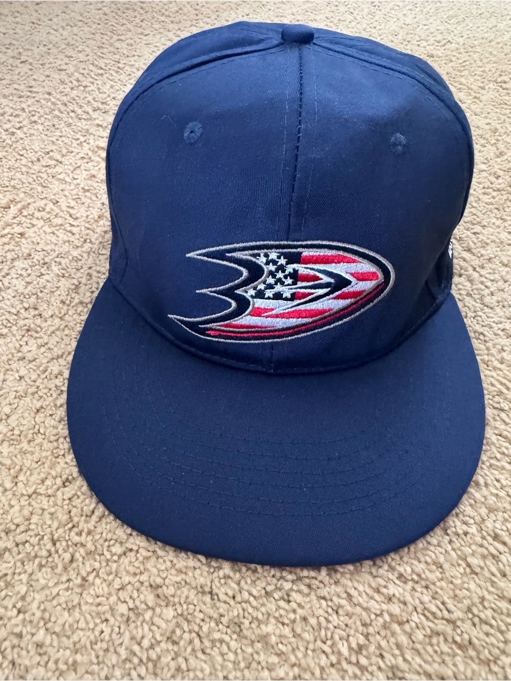 NWOT Anaheim Ducks red, white and blue hat with American Flag Print.